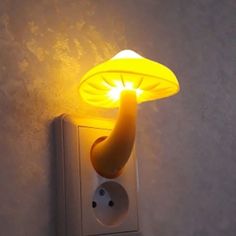 a light that is on the wall next to a plugged in phone charger