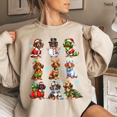 Stay cozy and festive with our dachshund christmas sweatshirt! This adorable dachshund christmas shirt is the perfect way to celebrate the holidays while staying warm. Designed for dachshund moms and dog lovers, this christmas crewneck is a fun and festive choice for holiday gatherings or lounging at home. It's also a great dog lover gift or dachshund new year shirt for any doxie fan. Whether you're decking the halls or unwrapping gifts, this dachshund mom shirt adds a festive touch to your holiday wardrobe! 🌟 HOW TO ORDER 🌟 Peek at the Pics: Take a moment to browse all the photos and fall in love with your new favorite tee. Pick Your Size & Color: Choose the perfect size and color combo to match your style. Add to Cart: Pop it in your cart, and if you want to add more goodies, feel free Winter Dog Print Crew Neck Top, Winter Crew Neck Top With Dog Print, New Year Shirt, Dog Mom Tee, Dachshund Mom, New Years Shirts, Dachshund Christmas, Christmas Crewneck, Color Magic