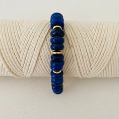 This is two looks in one bracelet. Half of the bracelet is beaded with gold and lapis beads and the other half is a chunky bold gold chain. It measures 18 inches in length and can be adjusted to a smaller size. Please note that the white bracelet shown in some of the photos is not included but can be purchased under Nico-White Gold Lapis Lazuli Beaded Bracelets With Round Beads, Everyday Blue Lapis Lazuli Beaded Bracelets, Hand-strung Gold Lapis Lazuli Bracelets, Gold Beaded Lapis Lazuli Bracelets, Everyday Blue Bracelets With Gold Beads, Handmade Gold Beaded Lapis Lazuli Bracelets, Adjustable Lapis Lazuli Beaded Bracelets For Everyday, White Bracelet, The Other Half