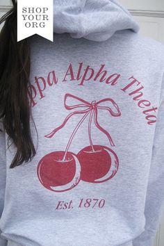 the back of a woman's hoodie with two cherries on it