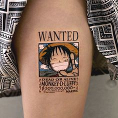 a person with a tattoo on their leg that says wanted and money - u - luffy