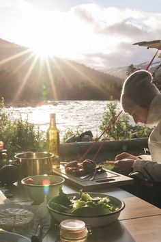 a man in chef's uniform preparing food on a table