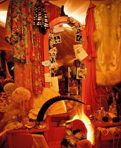 a room filled with lots of different types of clothing and accessories on display in front of a mirror