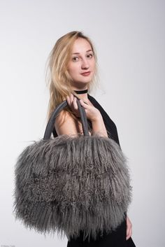 Handcrafted statement bag made of genuine Tibetan lambs wool.  The fur is lustrous and luxuriously soft with defined curls. Each bag is unique in character and feel, truly one of a kind, just like ... you! The unique thing about this bag is that you can wear it 3 different ways, for every occasion! On Your Arm: The comfortable suede handles allow you to wear your bag on your arm for a business chic look. On Your shoulder: Running errands, need both arms?  Your PEBBLE bag comes with a removable long chain that allows you to wear your bag on your shoulder or cross-body. For a more casual look, easily tuck in the handles and enjoy the freedom! Oh Clutch! Going to a formal event? Tuck in the handles, wrap the chain around your wrist for an added touch of glamour and voila.. you have a sleek cl Luxury Tote Bag For Winter, Luxury Faux Fur Evening Bag, Luxury Evening Bags In Faux Fur, Elegant Evening Shoulder Bag With Faux Fur Lining, Luxury Sheepskin Bag For Everyday Use, Luxury Faux Fur Shoulder Bag For Everyday Use, Elegant Rectangular Shoulder Bag With Faux Fur Lining, Elegant Faux Fur Bags, Elegant Rectangular Faux Fur Bag