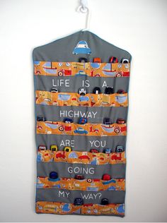 a wall hanging with cars on it and the words life is highway are you going my way?