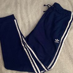 Navy, Adidas Originals Sweatpant, Signature 3-Stripe Details On Side, Navy Color, Size Small But Slightly Oversized Fit. New Without Tags Blue Sporty Sweatpants With Three Stripes Branding, Sporty Blue Sweatpants With Three Stripes Branding, Blue Sporty Bottoms With Contrast Stripes, Sporty Blue Bottoms With Contrast Stripes, Blue Athleisure Sweatpants With Side Stripes, Casual Blue Pants With Side Stripes, Sporty Blue Joggers With Three Stripes Branding, Blue Sweatpants With Three Stripes For Streetwear, Blue Sporty Joggers With Side Stripes