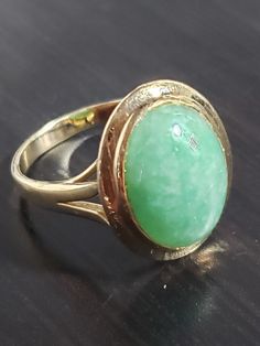 This stunning 14 karat yellow gold ring features a beautiful oval-shaped cabochon green jade stone that measures 11.5mm in width and 15.3mm in length. The stone is set in a classic bezel style and the ring is sizable to fit a finger size of 9.5. Crafted by RJ, a renowned jewelry brand, this fine piece is made of 14k gold and will surely catch the eye of anyone who appreciates the elegance of fine jewelry. Its color is a lovely shade of yellow and it comes with one gemstone. Perfect for any occasion and a great addition to any jewelry collection. Cabochon Ring, Jewelry Brand, Jade Stone, Yellow Gold Ring, Green Jade, Shades Of Yellow, Jade Green, Yellow Gold Rings, Jewelry Branding