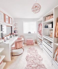 a white and pink bedroom with lots of closet space, including a dressing room table