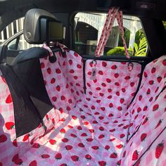 the inside of a car with ladybugs on it's pink and white cover