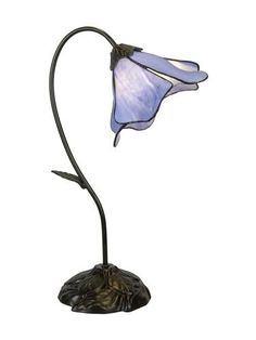 a blue glass flower on a black metal base with a white light in the middle