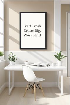 a white desk with a black framed poster above it that says start fresh dream big work hard