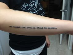 a woman with a tattoo on her arm that says we accept the love we think we deserves