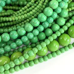 a pile of green beads sitting next to each other