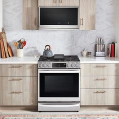 a white stove top oven sitting inside of a kitchen