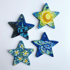 four hand painted ceramic stars on a white surface