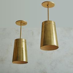 two brass pendant lights hanging from the ceiling