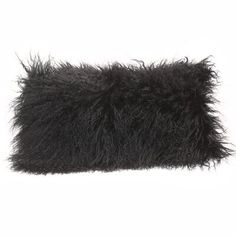 a black furry pillow on a white background