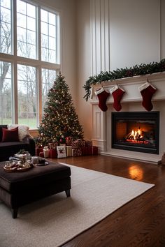 a living room filled with furniture and a fire place covered in christmas stockings next to a large window