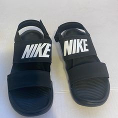 Nike Sandals Black With White Logo Woman’s Size 6. New With Tags. Never Worn Or Used. Great Quality And Condition. S601 Nike Slide Sandals, Nike Flip Flops, Sperry Duck Boots, Nike Sandals, Nike Tanjun, Rubber Sandals, Pink Nikes, Nike Shoes Women, Blue Sandals