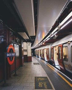 a subway train pulling into the station with its doors open