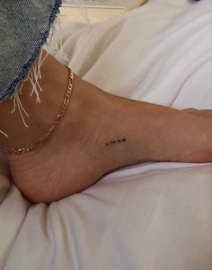 a woman's foot with the word mom written on it and a chain around her ankle