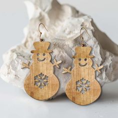 wooden earrings with snowman design on them