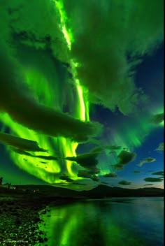 an aurora bore is seen in the sky above water