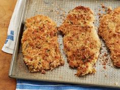 three pieces of fried chicken on a baking sheet