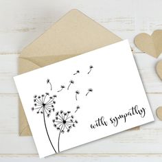 a greeting card with a dandelion and the words, with sympathy on it