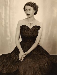 an old black and white photo of a woman in a dress