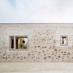 a white brick wall with a window on it