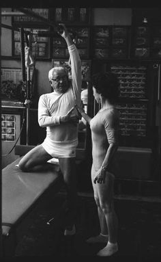 an old photo of two women doing yoga in front of a man sitting on a bench