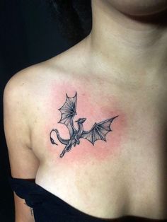 a woman with a dragon tattoo on her chest