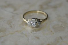 a diamond ring sitting on top of a marble surface