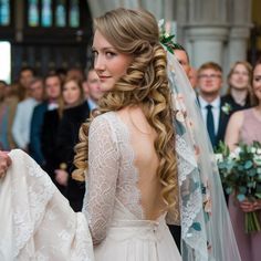 a woman in a wedding dress standing next to a man