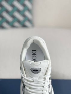 Embrace a sleek and sporty aesthetic with these Dior B30-inspired sneakers in a pristine white colorway. Crafted with breathable mesh and technical fabric, these shoes are perfect for those who value style and performance. The lightweight construction and sculpted rubber sole ensure all-day comfort and support, while the signature "CD30" logo adds a touch of Dior's iconic style. Whether you're hitting the gym or the streets, these sneakers will elevate your look with a touch of understated luxur White Mesh Running Shoes With Abzorb Midsole, White Mesh Running Shoes With Medium Fit, White Mesh Running Shoes Medium Fit, White Sneakers For Sports, White Mesh Running Shoes, Functional Medium Fit White Running Shoes, Luxury Low-top Sneakers With Air Cushioning, White Breathable Sneakers, Medium Fit, White Breathable Sneakers Medium Fit