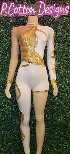 a mannequin with gold sequins and white bodysuit in front of a green wall