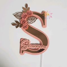 a cake topper with the letter s on it