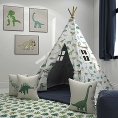 a teepee tent with dinosaurs on it