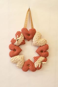 a red and white checkered ribbon wreath hanging on a wall