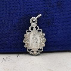 A beautiful genuine antique Virgin Mary pendant, petite French religious necklace charm, dainty necklace charm in Art Nouveau style. The reverse has inscription 'Souvenir de Notre-Dame de Liese' (see photo 2). Ideal for dainty necklace, would make a nice gift for someone special! Material: silver, hallmarked Measures: 23 mm (0.9 inch) tall Box on photos is NOT included! A stunning religious jewelry shop well worth a visit ... https://www.etsy.com/shop/SacredMagic Silver Vintage Charm Oval Pendant Jewelry, Silver Oval Pendant With Vintage Charm, Ornate Vintage Charm Sterling Silver Jewelry, Ornate Vintage Sterling Silver Jewelry, Ornate Sterling Silver Jewelry With Vintage Charm, Vintage Silver Necklaces For Memorial, Vintage Silver Pendant Jewelry, Silver Necklaces With Oval Pendant Vintage Charm, Silver Necklace With Oval Pendant And Vintage Charm