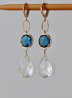 Elegant Earrings with Faceted Clear Crystal Pear Drops 17 x 12 mm Faceted Blue Sapphire Glass Stones in Gold Plated Bezel setting 12 x 12 mm Gold plated Lever back Round Ear clasp. The total length is 2.3 inches or 58 mm * *.* * * * * * * * * * * * * * * * * * * * * * * * * * * * Your order will be wrapped and shipped in jewelry gift box. Please enter my shop here - www.etsy.com/shop/ZarinaJewelry or my FB page - facebook.com/ZarinaJewelry Faceted Drop Earrings Jewelry For Wedding, Faceted Drop Earrings For Wedding, Teardrop Faceted Earrings For Wedding, Faceted Teardrop Earrings For Weddings, Wedding Teardrop Faceted Earrings, Blue Briolette Earrings For Wedding, Faceted Crystal Earrings For Wedding, White Faceted Earrings For Wedding, Briolette Faceted Wedding Earrings