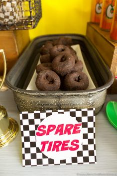 there are some donuts that are in the pan and on the table next to each other