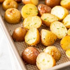 potatoes on a baking sheet ready to be cooked