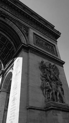 black and white photograph of an arch with statues on it