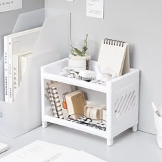 a white shelf with books and other items on it