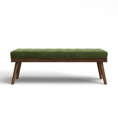 an upholstered bench with wooden legs and a green cushion on the top, in front of a white background