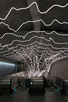 an escalator with motion blurs in the background and lights on the ceiling