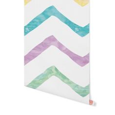 a white notebook with colorful watercolor chevrons on it