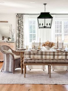 a dining room table with chairs and a bench